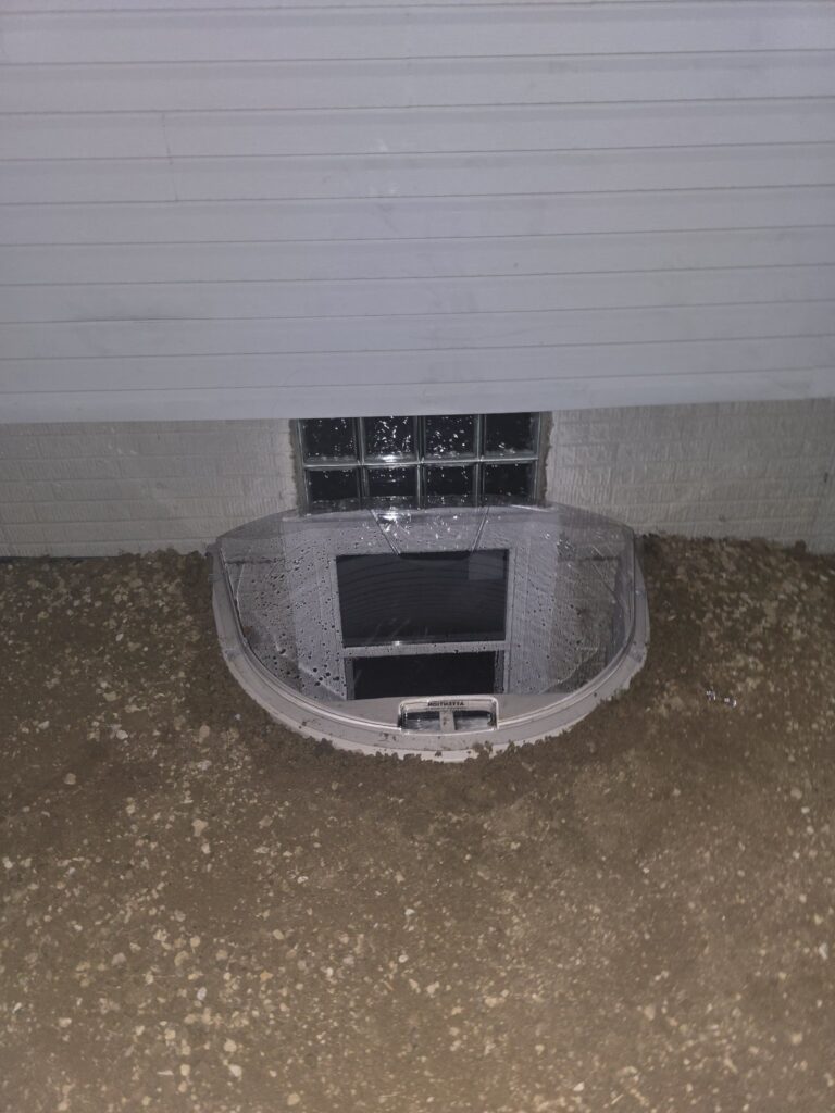 Exterior egress window well at night
